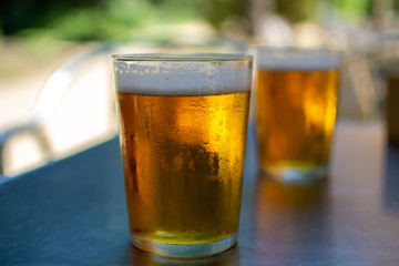 Cold amber color light spanish beer served in glass in outdoor cafe in sunny Andalusia, Spain