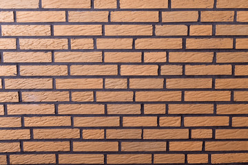 Yellow brick wall with black joints