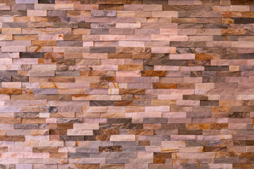 Colourful brick stone wall from natural stone