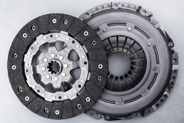 Close-up picture of a part of car, black clutch disk isolated on white background