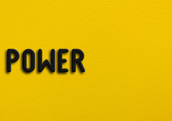 “Power” on yellow leather background