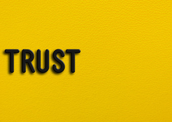 “Trust” on yellow leather background