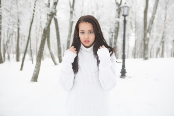 Outdoor portrait of cute girl  white warm sweater