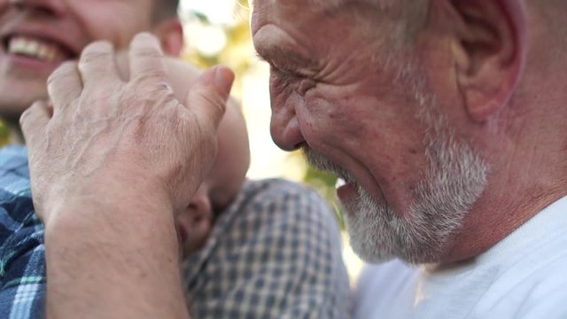 Grandfather,Father And Grandson Sitting Outdoors. Three generations of the same family, fathers day