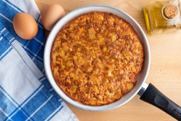 Close-up of homemade (Spanish) potato omelette with natural ingredients (fresh eggs, olive oil, potatoes, onion, chorizo)