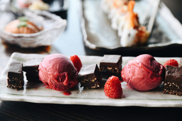 Raspberry sorbet with chocolate squares served on plate