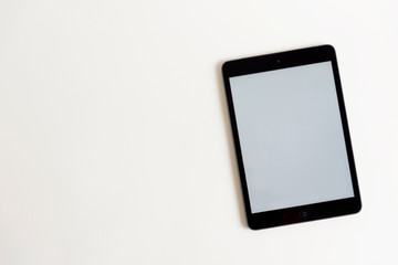 Black touch screen tablet in iPad style with blank screen area for copy space white background 