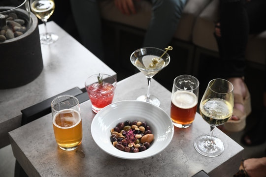 Drinks served with bowl of olives and pine nuts