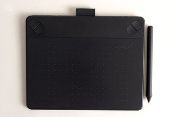 Black graphic tablet with pen for illustrators and designers. Graphic digital touch tablet with...