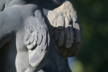 The wings of an angel. Backside view of a  sandstone sculpture of an angel.
