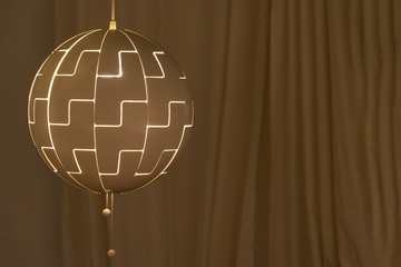 Modern golden ceiling lamp light bulb ball shape geometry with golden curtain background design decoration contemporary interior concept