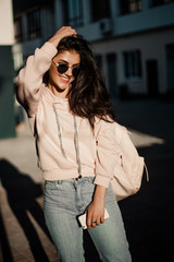 Fototapeta premium Woman walking with phone on the streets.