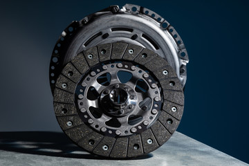 Close-up picture of a part of car, black clutch disk isolated on black background