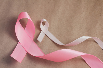 Pink ribbon. Symbol of breast cancer awareness. Health care conception. Preventive measures. October checking time. Women health. Craft paper background.