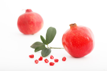 Fresh pomegranate with leaves isolated on white background. Ripe, juicy pomegranate.
