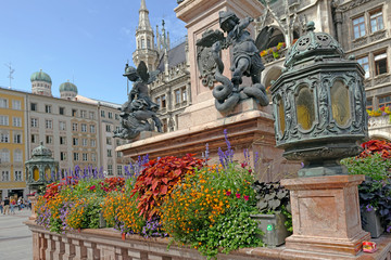 Putto Statue and floral display in front of the Neues Rathaus (New Town Hall) in Marienplatz, Munich, Bavaria, Germany - 299787886