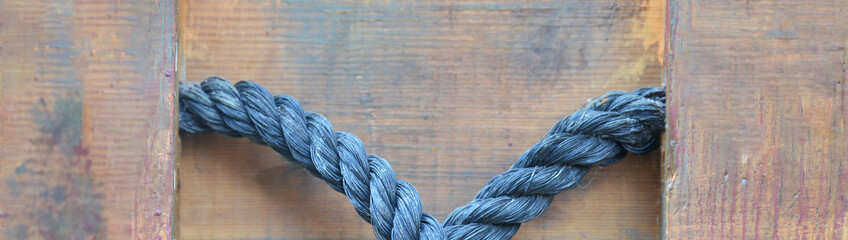 Fototapeta na wymiar blue rope on wooden background