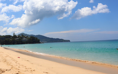 view of patong beach in phuket, sea waves roll on the sandy shore, foam and spray of water