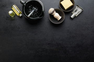 Obraz na płótnie Canvas Shaving accessories set on a dark background, top down view