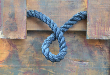 Obraz na płótnie Canvas blue rope on wooden background