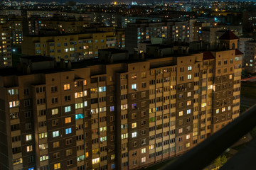 Night panorama of Light in the windows of a multistory building. life in a big city