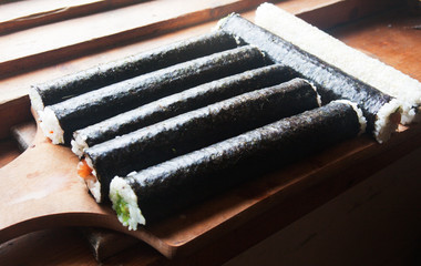 Big sushi rolls in nori. Candid.