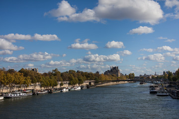 Fototapeta na wymiar View of river channel in Paris France fluffy cloudy blue sky 