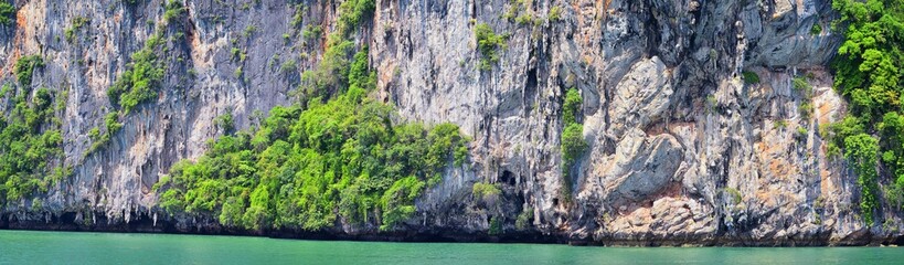 Island, Ocean views near Phuket Thailand with Blues, Turquoise and Greens oceans, mountains, boats, caves, trees resort island of phuket Thailand. Including Phi Phi, Ko Rang Yai, Ko Li Pe and other is