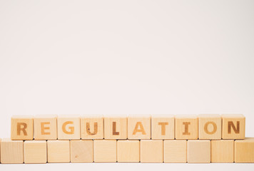 REGULATION word with Wooden Blocks.Concept for Regulation Compliance Rules Law.