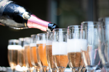 champagne being poured into glasses © Alexander