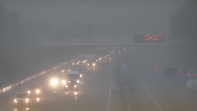 Heavy rainy day on a highway lots of traffic car lights France 