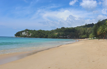 Fototapeta premium view of patong beach in phuket, sea waves roll on the sandy shore, foam and spray of water