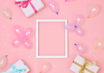 Christmas composition frame with decorations and gift box with confetti on pink pastel background. winter, new year concept. Flat lay, top view, copy space.