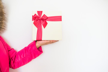 Woman hands holding Gift box with red bow on white background.Concept for delivery gift on holidays and winter time.