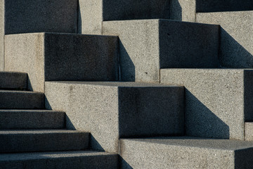 Abstract stairs, steps made of granite, often seen on monuments and landmarks,diagonal lit by bright sun light
