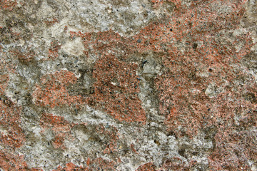 Texture of a colorful natural stone with inclusions