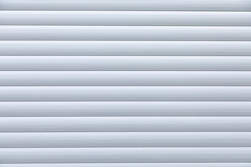 Close-up of white metal corrugated roller-shutter door