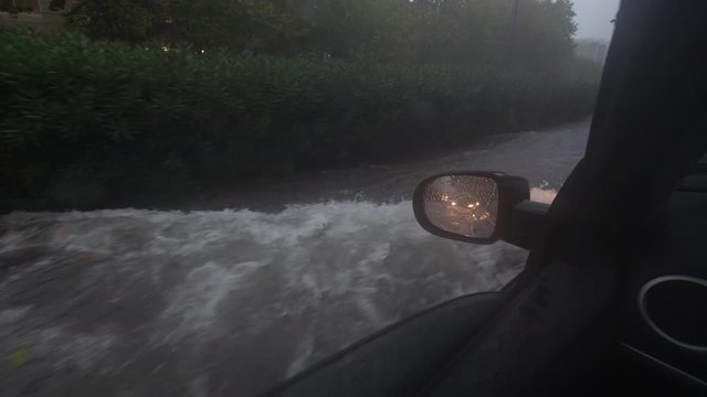 Flooded street car driving during heavy rain on a road lots of water Montpellier Antigone France