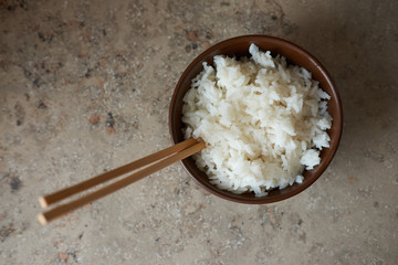 Tradition chainese rice in brown clay bowl, view from above