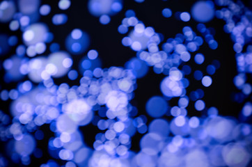 Abstract bokeh light blue festoon on dark background