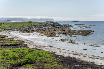 bay with white sand beach and scatterd cliffs, Stave , Norway