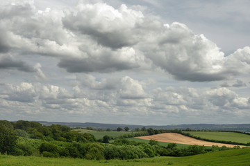 Fototapeta na wymiar Cloudy sky over the Vale of Aylesbury, Buckinghamshire, United Kingdom showing open green fields for miles