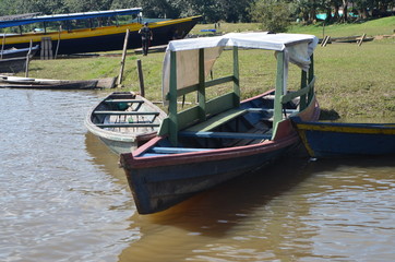 Fototapeta na wymiar Typical wooden boats for transportation in the Amazon River Colombia