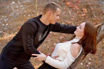 Beautiful young man and girl in the woods