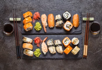 Fotobehang sushi rolls with rice and fish, soy sauce on a dark stone background © Наталья Майорова
