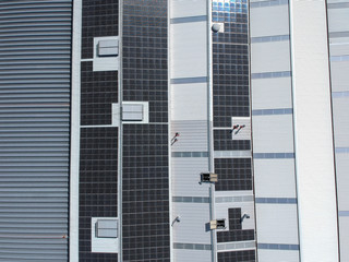Solar panels on the roof of a factory for producing of green ecological electricity. Drone view