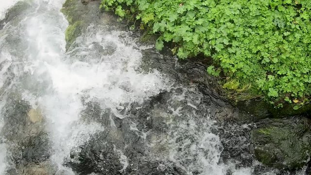 Top view of the bubbling water of a mountain river. Beautiful stream of wild nature. Environmentally friendly places of Poland.