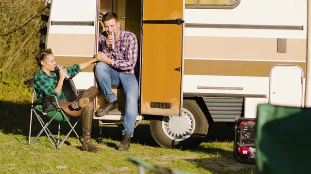 Boyfriend sitting on the stairs of camper van