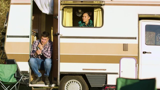 Boyfriend sitting on the stairs of camper van