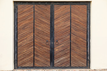 Massive wooden gates with knockers